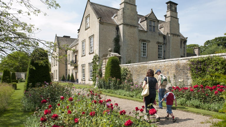 Visitors outside the south front of Nunnington Hall, North Yorkshire